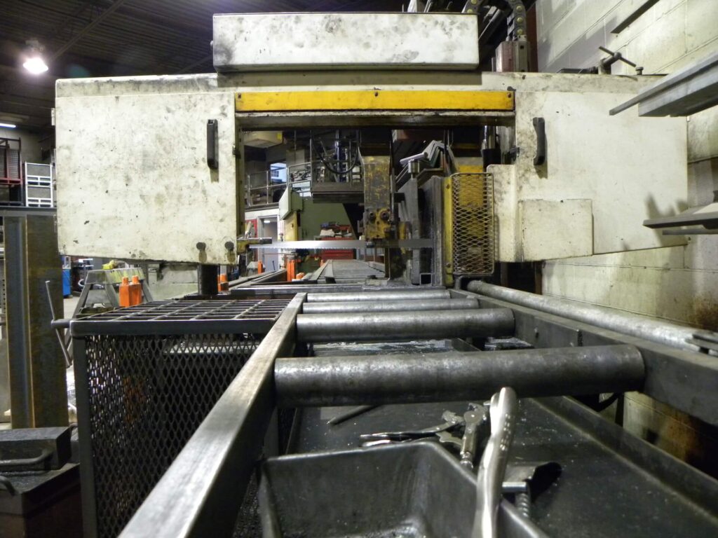 View inside a manufacturing facility showing machinery and equipment for processing metal materials. The scene emphasizes industrial workspaces and tools.